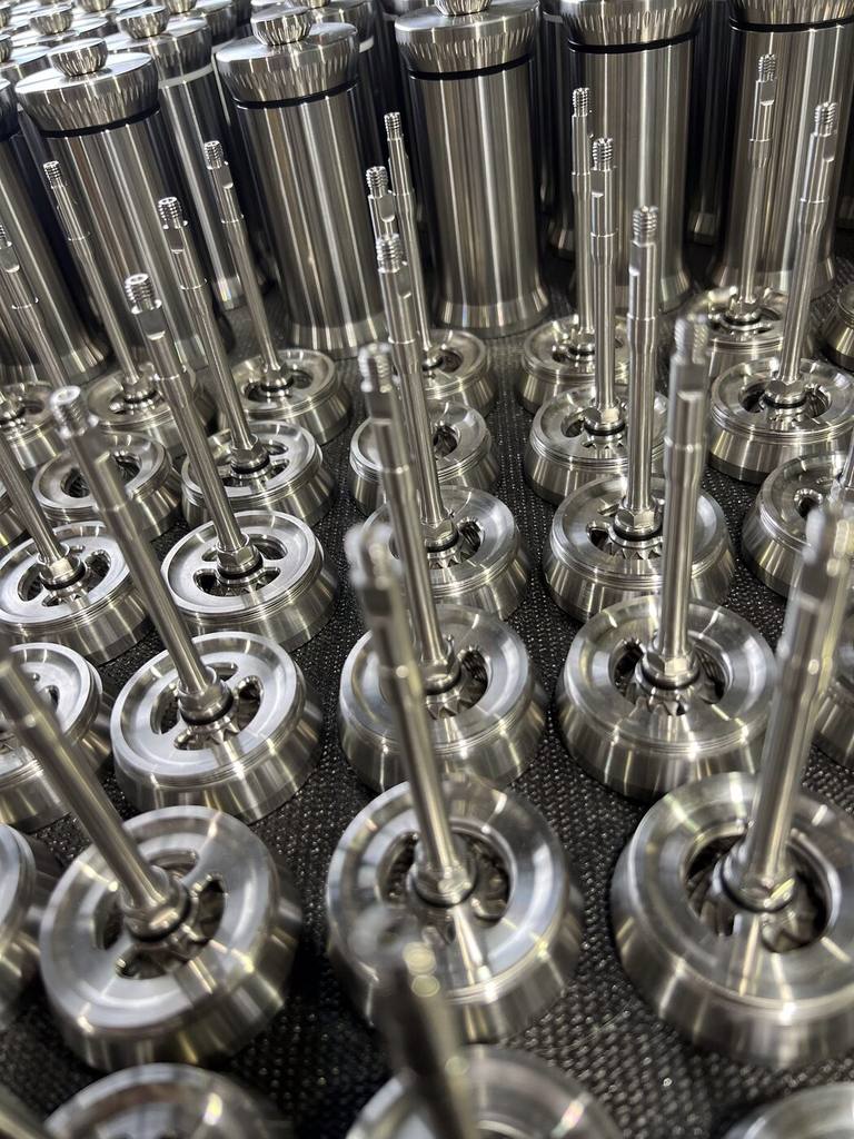 Rows of turned bodies and knurled crowns